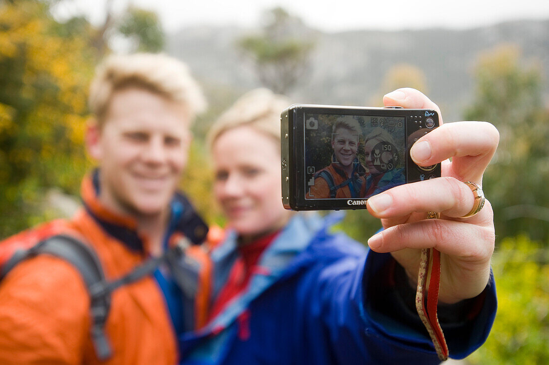 Two hikers taking a photograph of themselves near Little Oberon Bay, Wilsons Promontory National Park, Victoria, Australia
