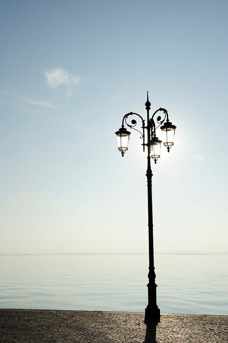 Street lamp at the seaside promenade of Lake Garda, Lazise, Lake Garda, Veneto, Italy, Europe