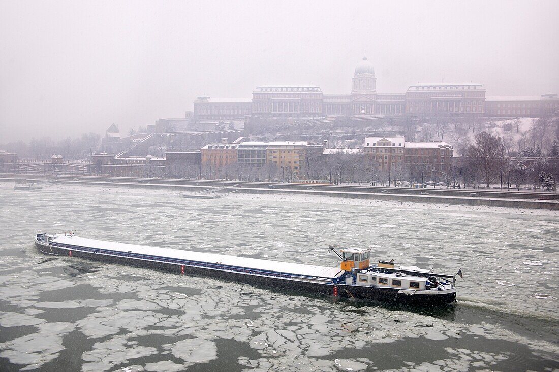 Ice on the frozen Danube and winter snow Budapest .