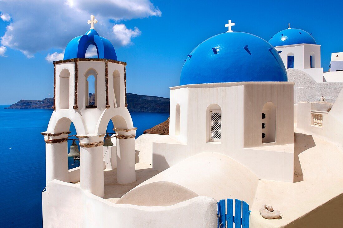 Oia, Ia Santorini - Blue domed Byzantine Orthodax churches, Greek Cyclades islands.