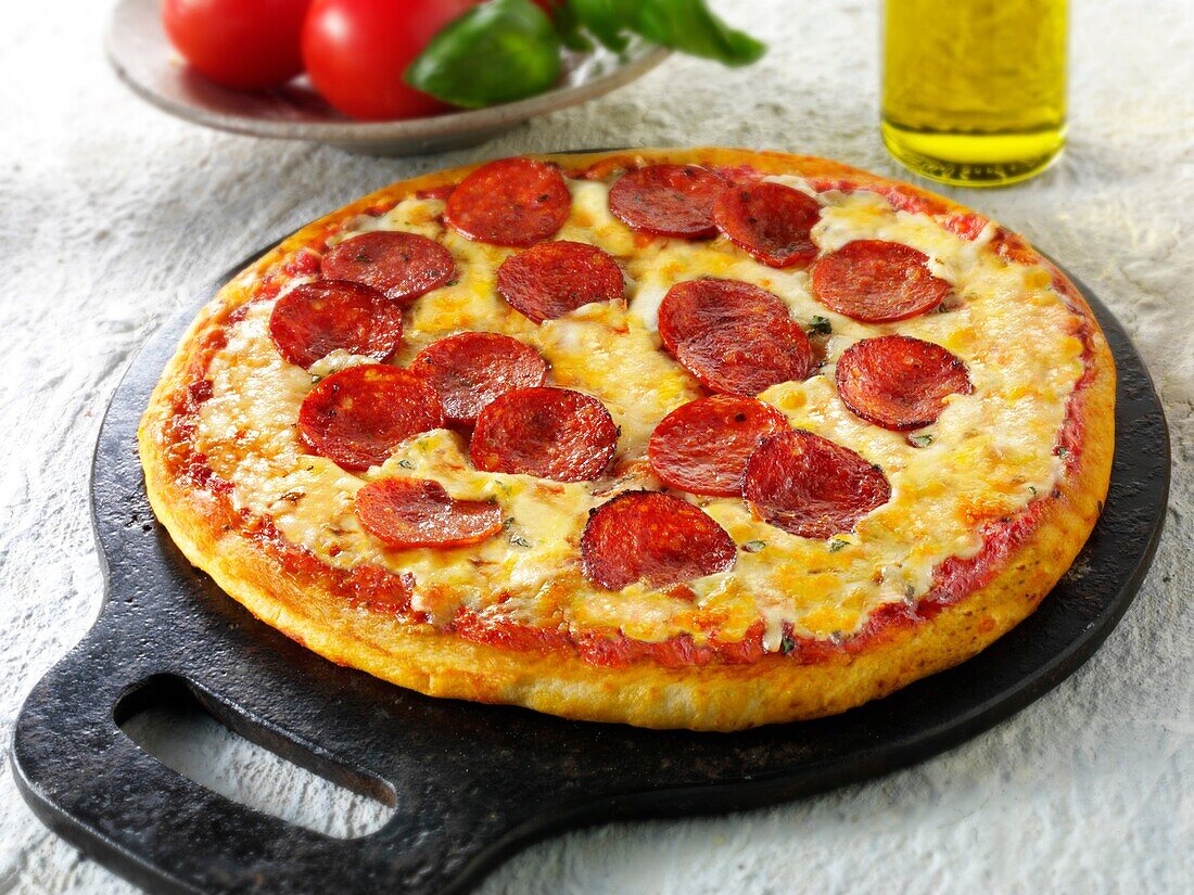 Pizza topped with pepperoni & cheese with a slice out