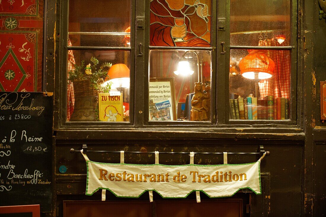 Strasburg, Alsace, France Traditional restaurant window with a sign offering : Specialites