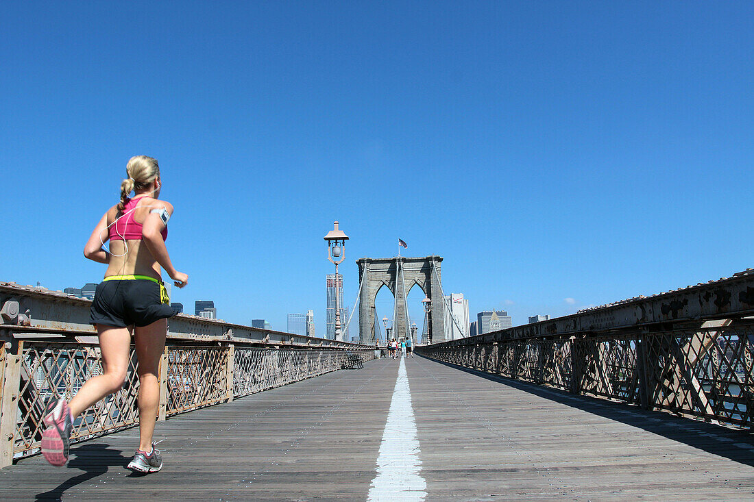 Jogger Crossing on the Footbridge of the Brooklyn Bridge, New York City, New York State, United States