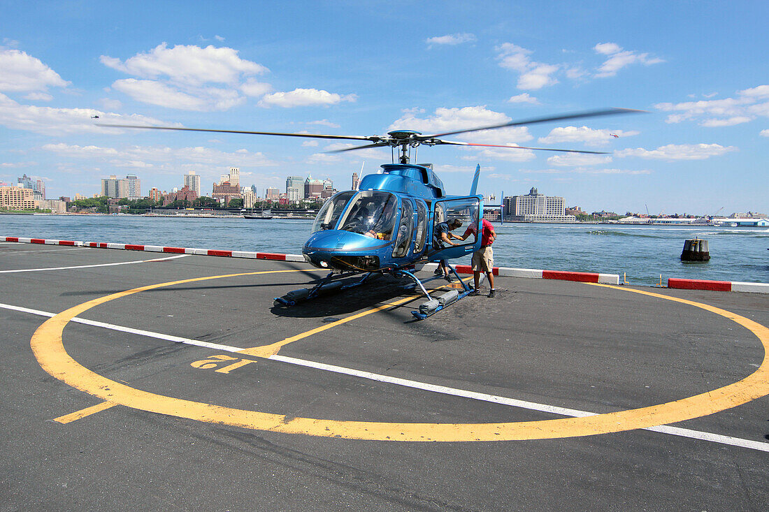Tourists Getting Off a Helicopter After a Flight Over New York, Helicopter Flight Services, Manhattan Heliport, New York City, New York State, United States