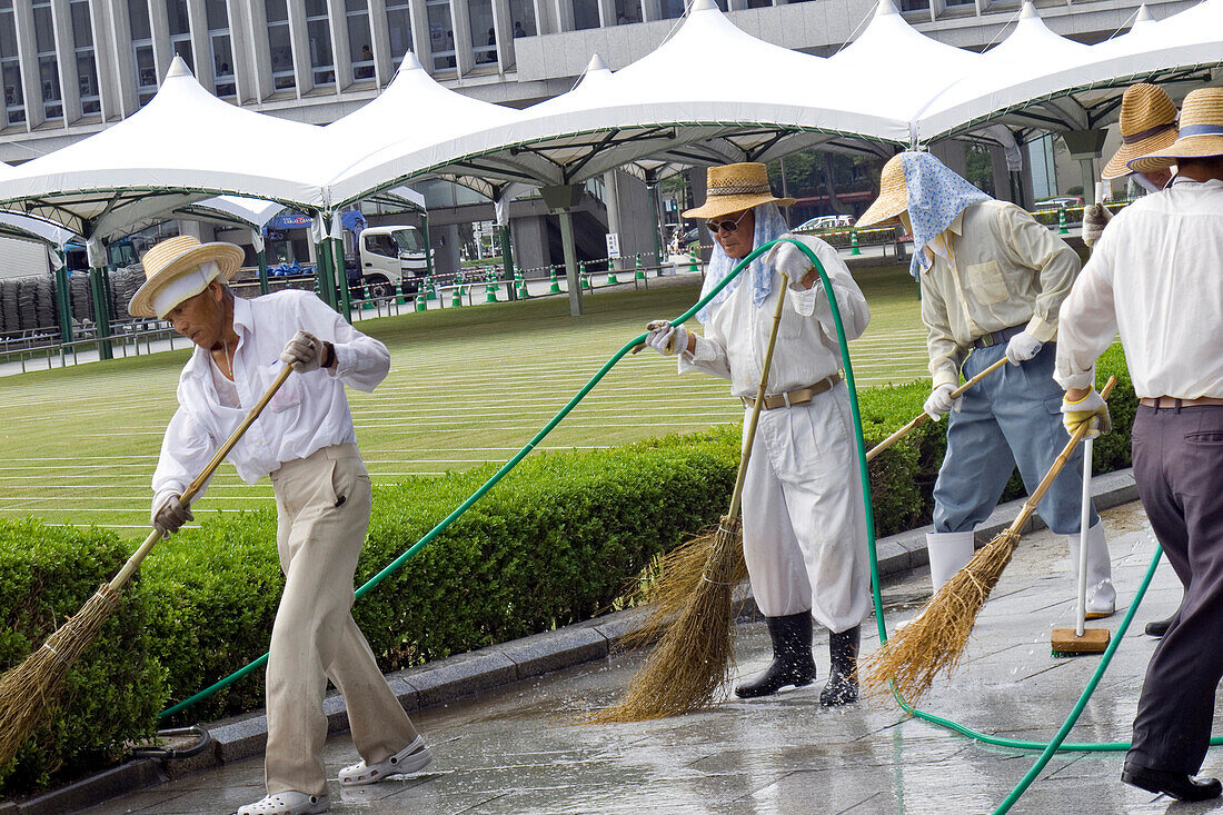 A Group of Sweepers Cleaning Up at the World Heritage Peace Memorial Park, Hiroshima, Japan