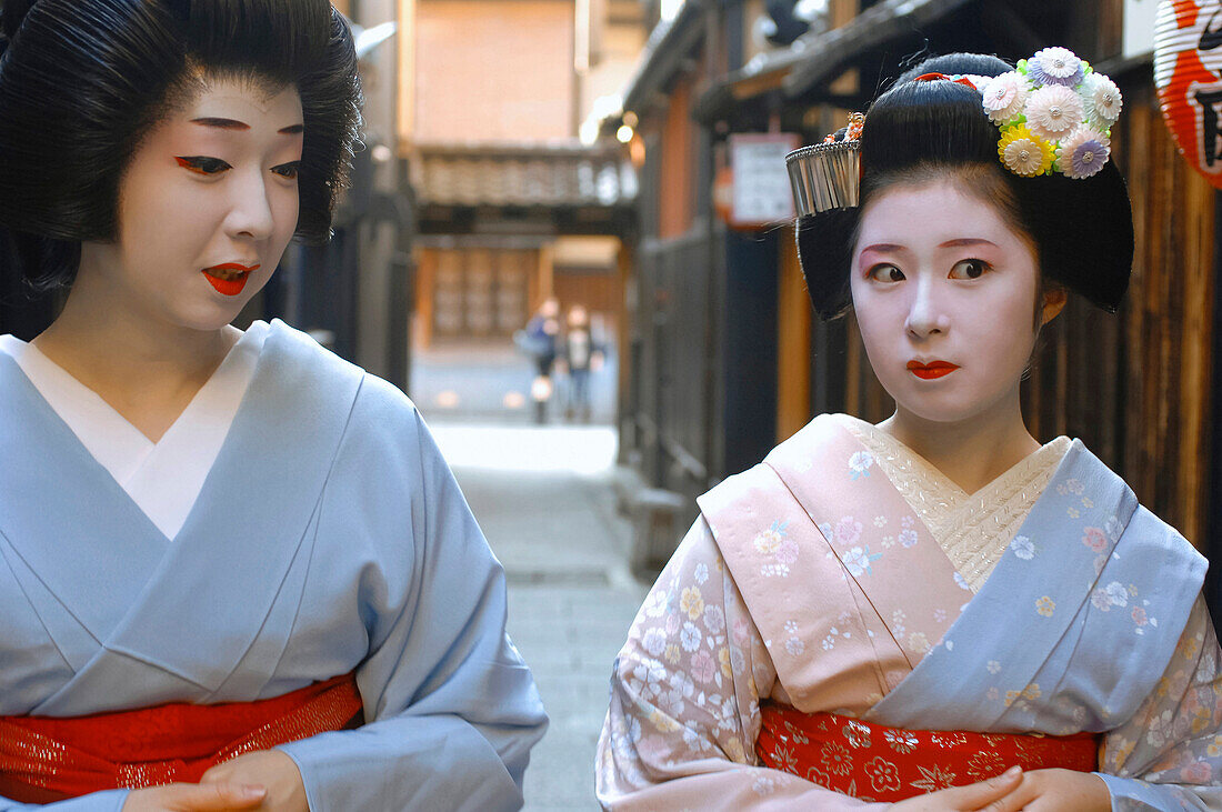 A Geiko (Geisha), on the Left, and a Maiko (Apprentice) Wearing a Kimono (Obebe) Held Closed By a Wide Belt (Obi) and Wood Sandals (Okobo) Walking Down a Street, Gion District, Kyoto, Japan, Asia