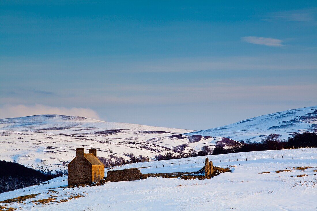 Scotland, Scottish Highlands, Cairngorms National Park Derelict farm buildings on the snow covered hills near Tomintoul