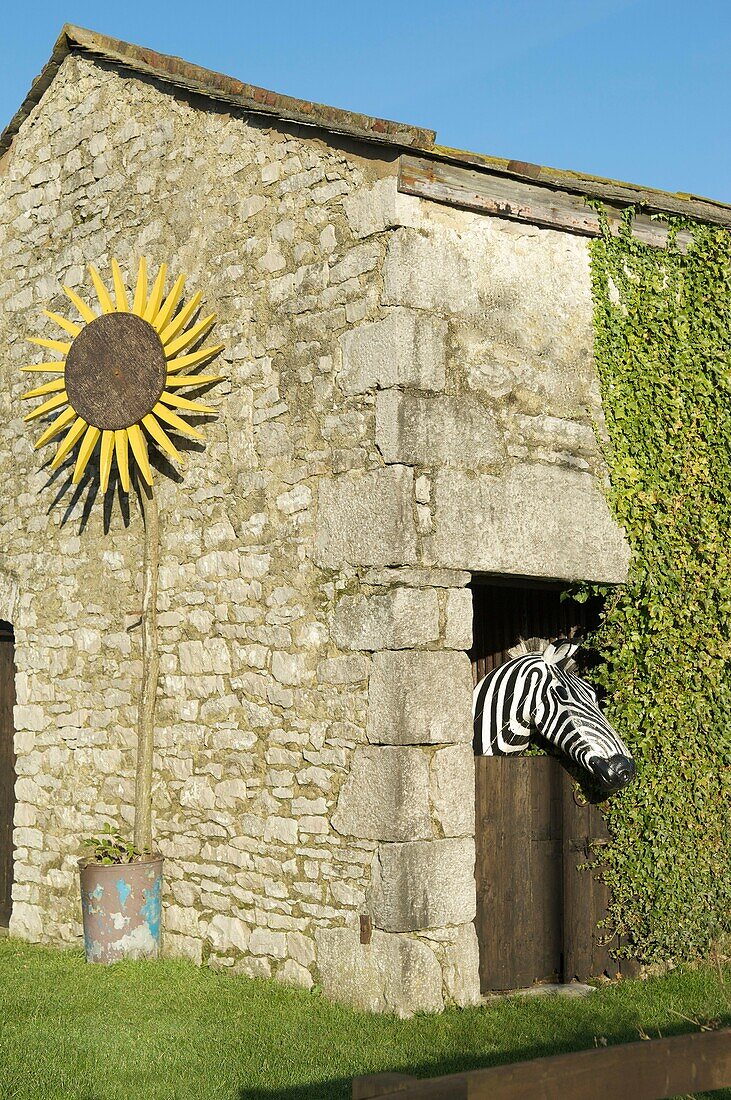 Model of a zebra looking out over stable door