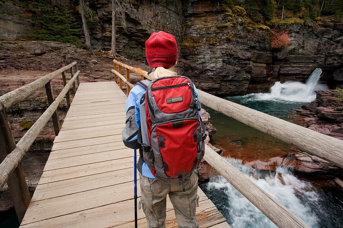 Woman hiker at Saint Mary falls near Saint Mary Lake, Glacier National Park