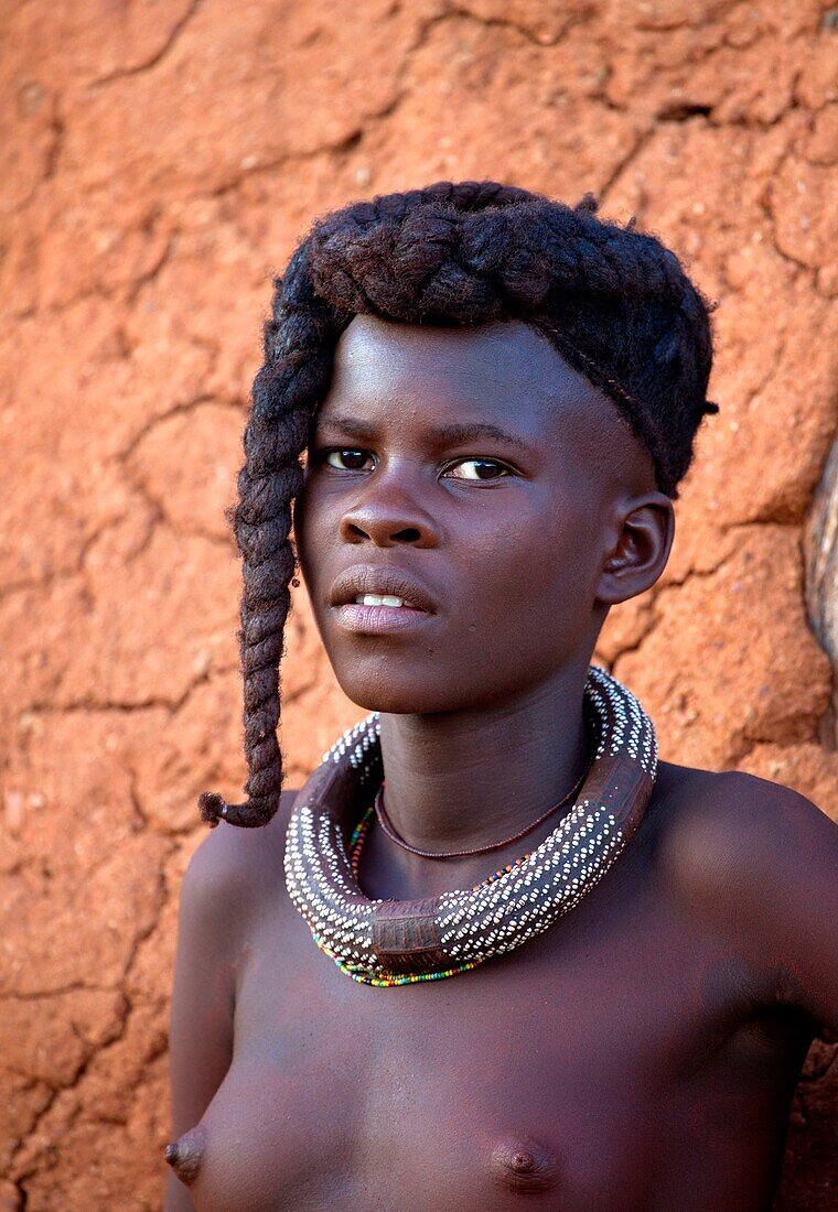 Himba girl, with the typical double plait hairstyle and necklace, Damaraland region, Namibia