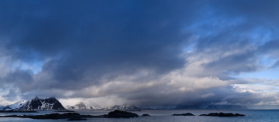Moutnains peaks rise from sea, viewed from Stamsund, Vestvågøy, Lofoten islands, Norway