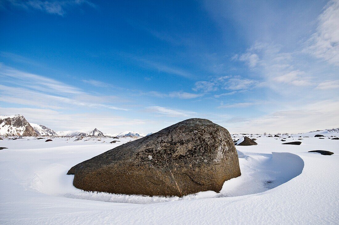 Large boulder in snow covered winter landscape, Near Stamsund, Vestvågøy, Lofoten islands, Norway