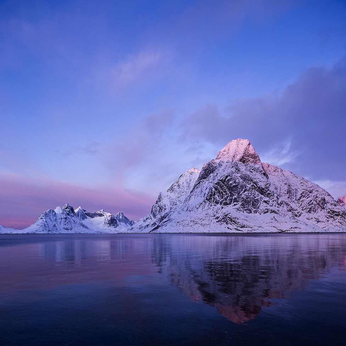 Reflection of winter mountain peaks in Kjerkefjord, Reine, Moskenesøy, Lofoten islands, Norway