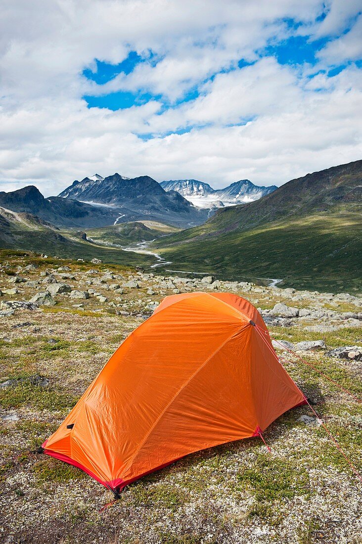 Backpacking tent in mountain landscape with Memurudalen in background, Jotuhnehimen national park, Norway