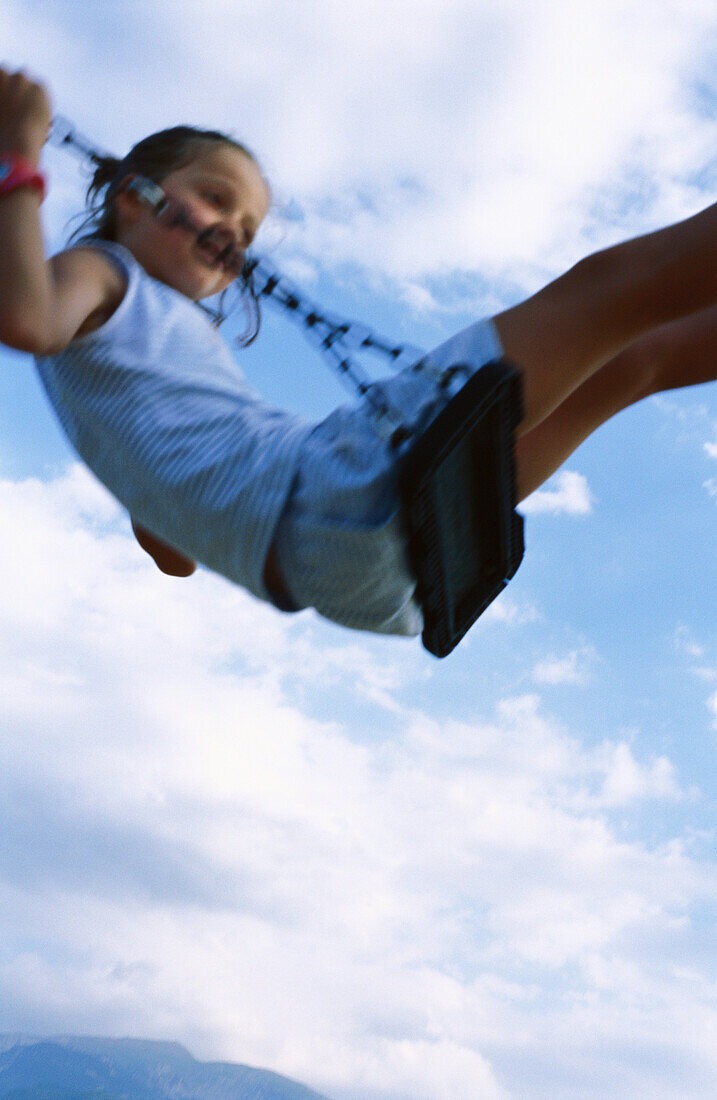 Girl on swing, low angle view