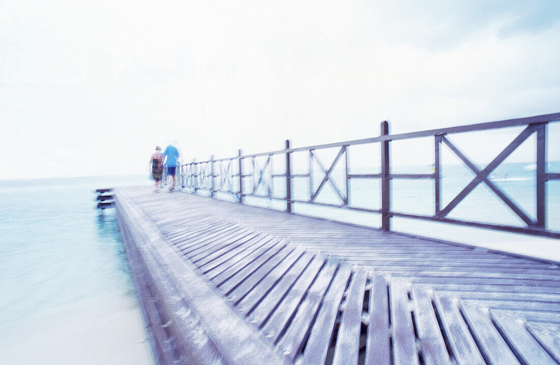 Couple walking on pier