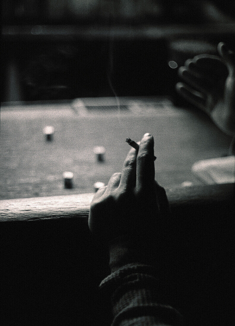 Hands with Cigarette Rolling Dice