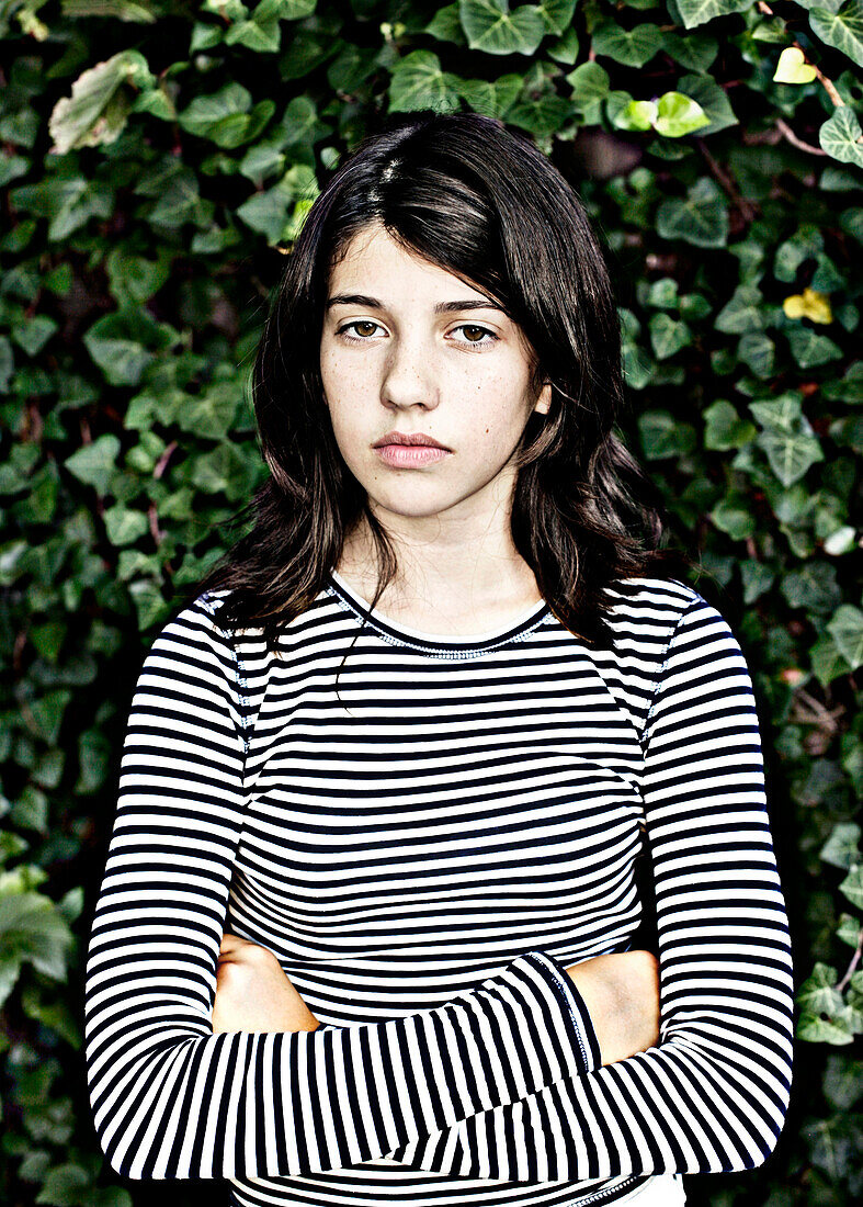 Teenage Girl Against Vine Covered Wall