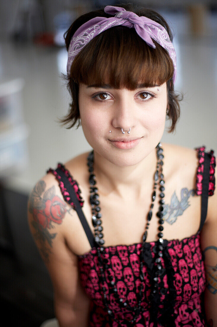Young Woman With Tattoo and Pierced Nose