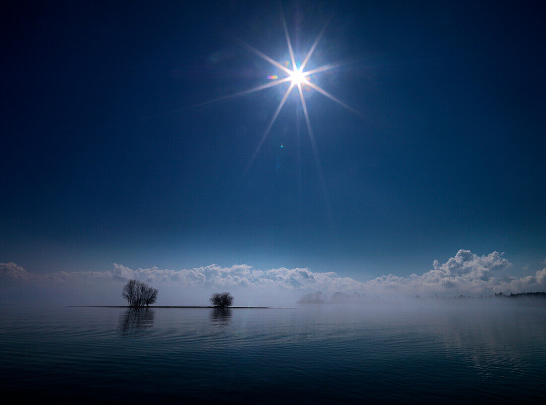 View from Krautinsel towards the cloud-covered Alps, Lake Chiemsee, Chiemgau, Bavaria, Germany