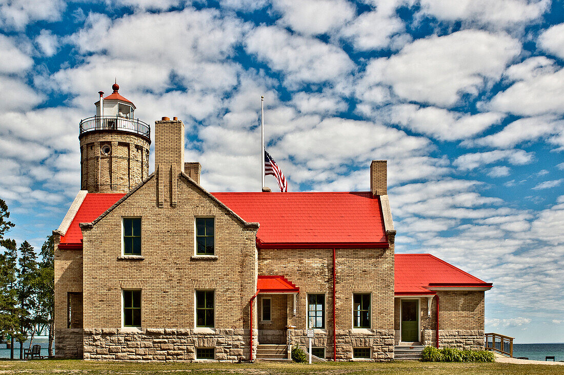 Rustic Lighthouse with a Flag at Half Mast, Mackinac Island, Michigan, US