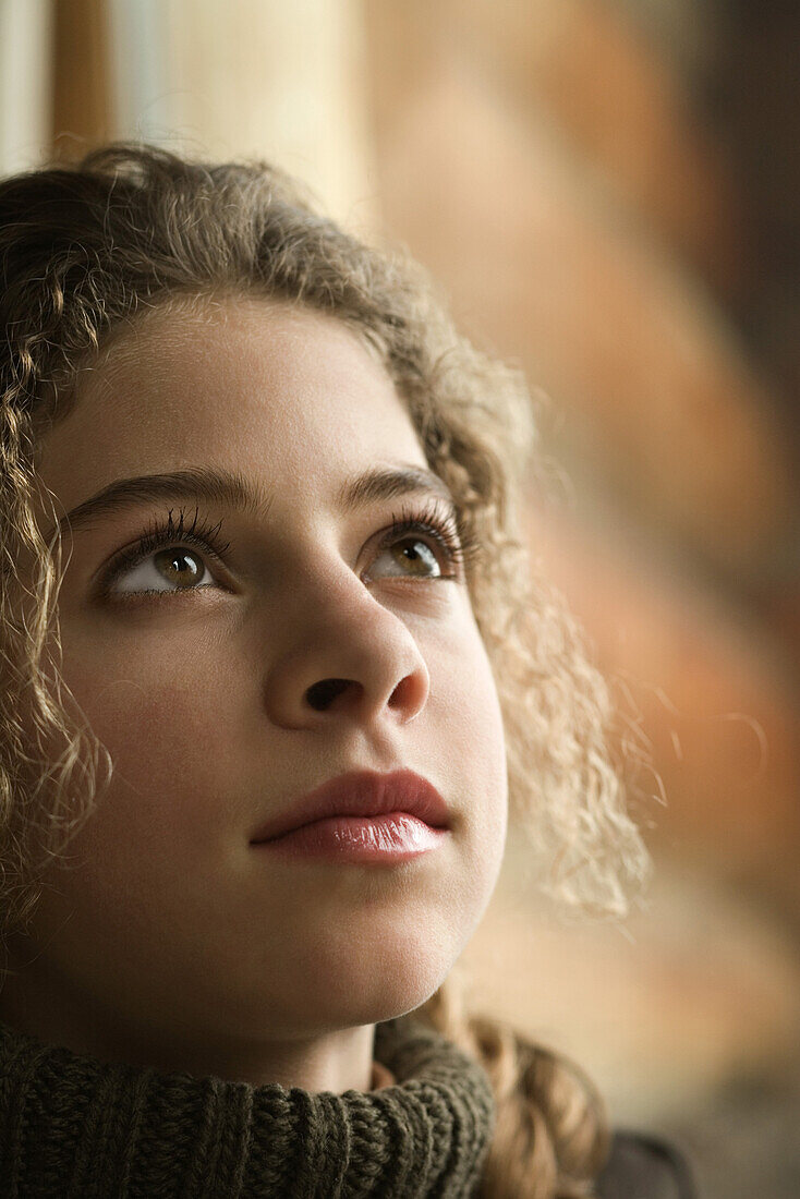 Teenage girl looking up, portrait