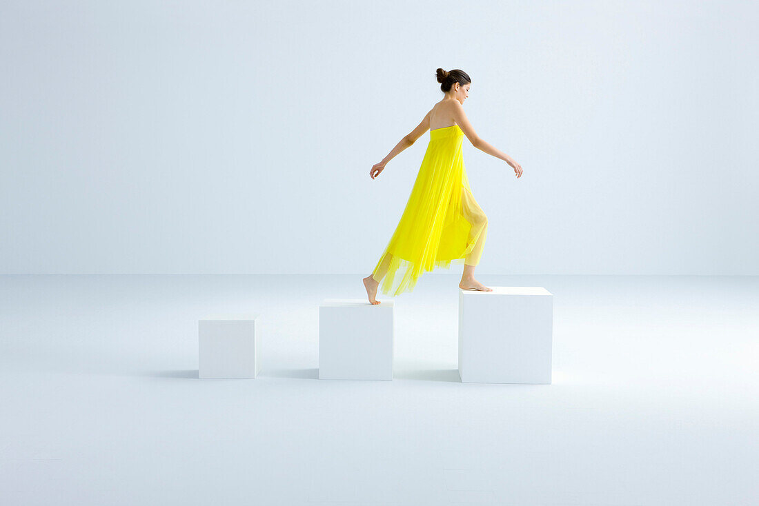 Woman stepping on progressively larger blocks