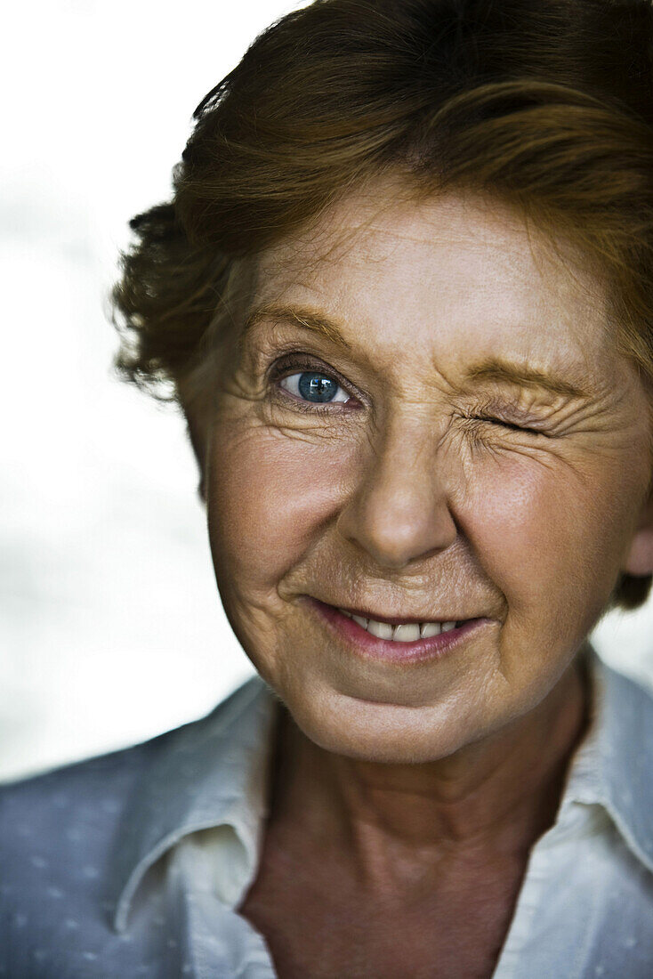 Senior woman winking, portrait