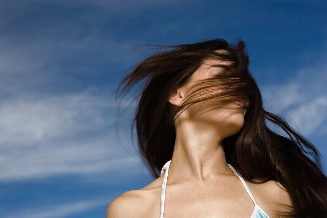 Young woman tossing hair in breeze