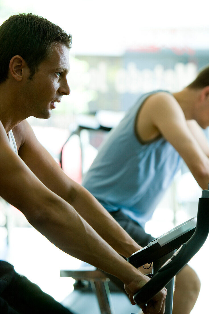 Man on exercise bike in gym