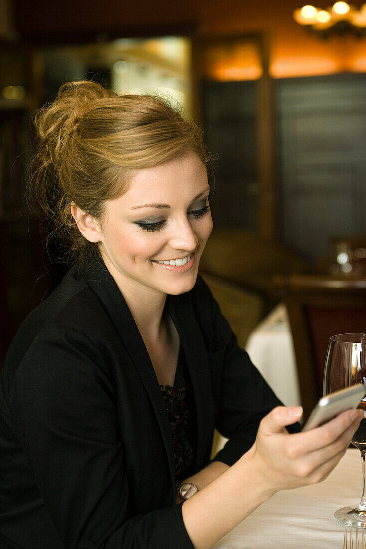 Woman text messaging in restaurant