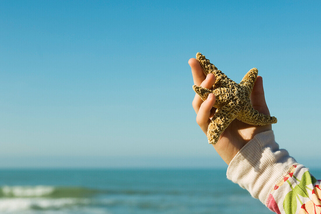 Female holding starfish