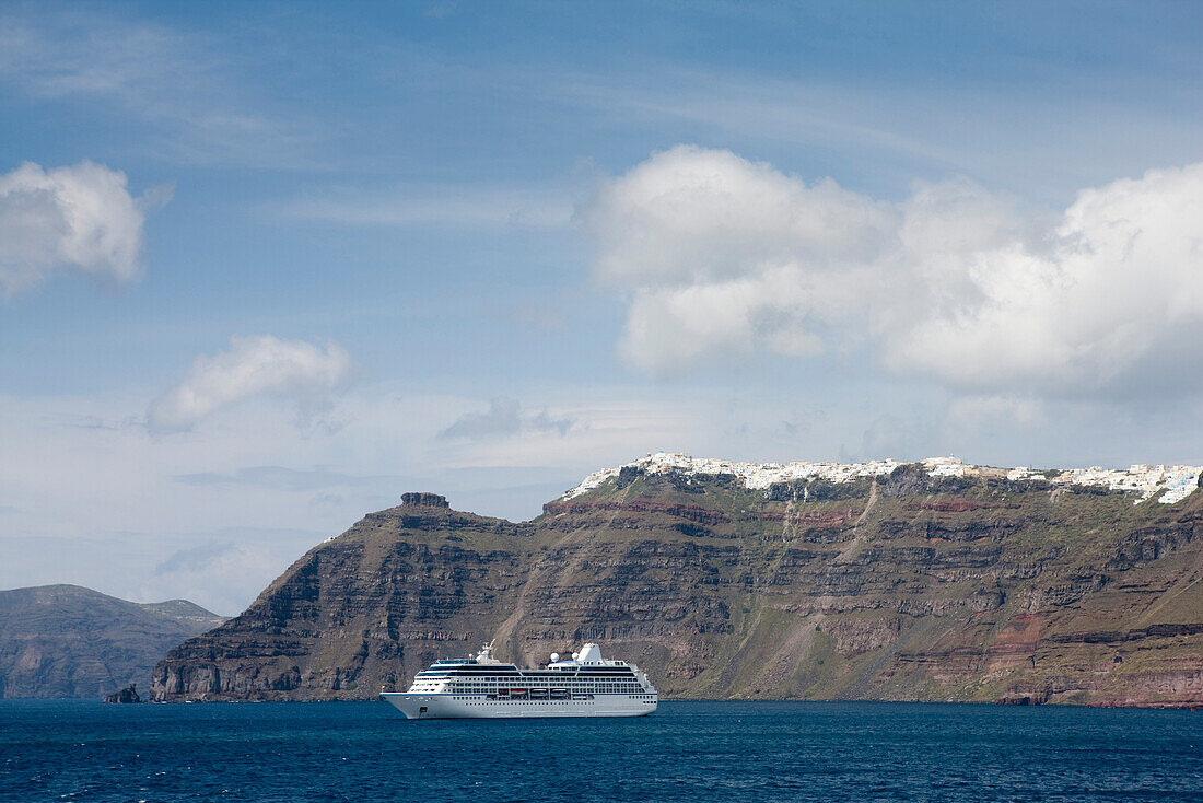 Greece, Cyclades, cruise ship passing beneath the Island of Santorini (Thera)