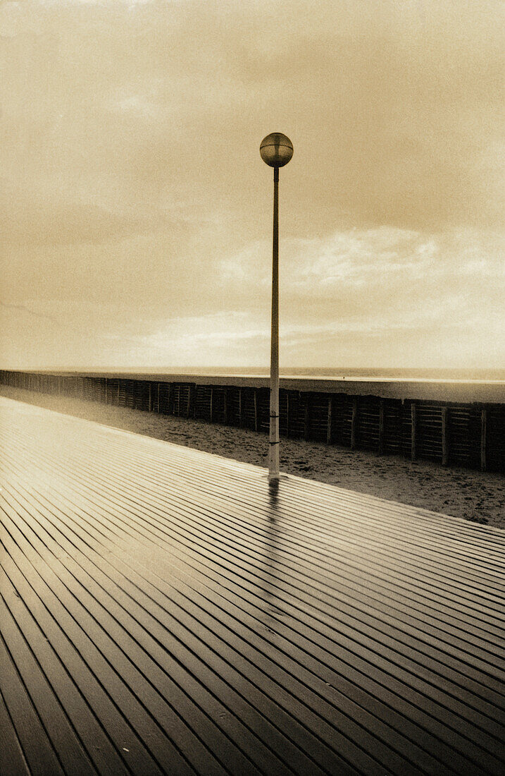 Lamp post next to walkway, b&w, toned