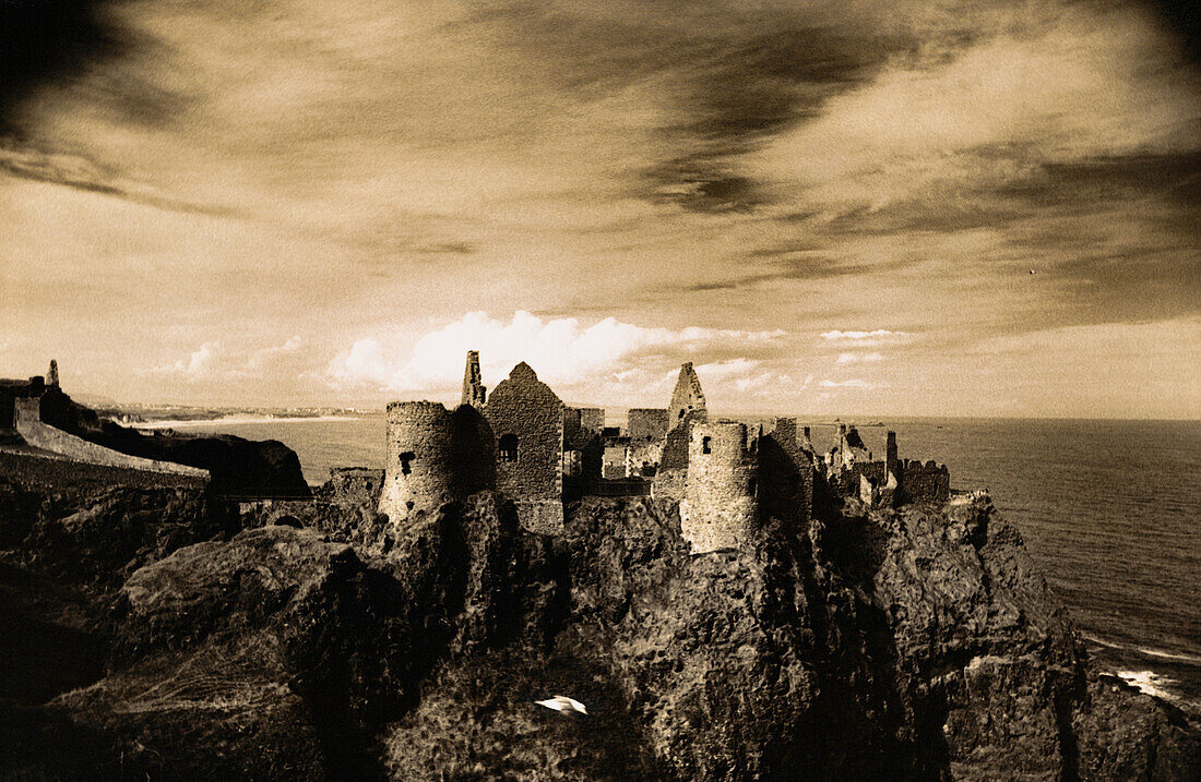 Scotland, ruins of castle on cliffs, b&w