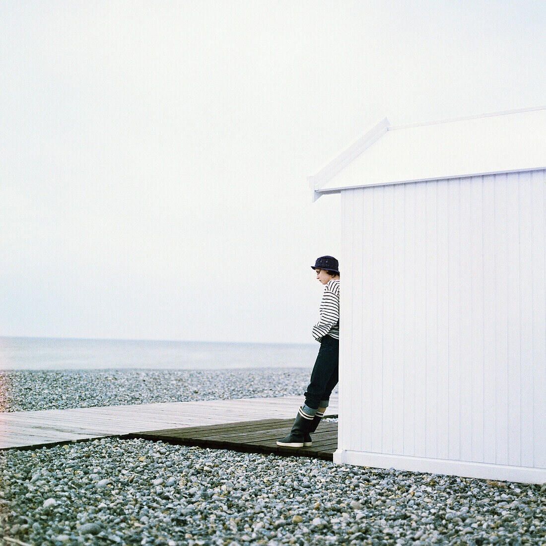 Woman leaning against beach cabana