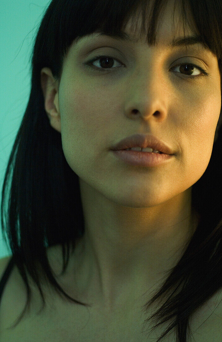 Woman with dark hair, looking at camera, portrait