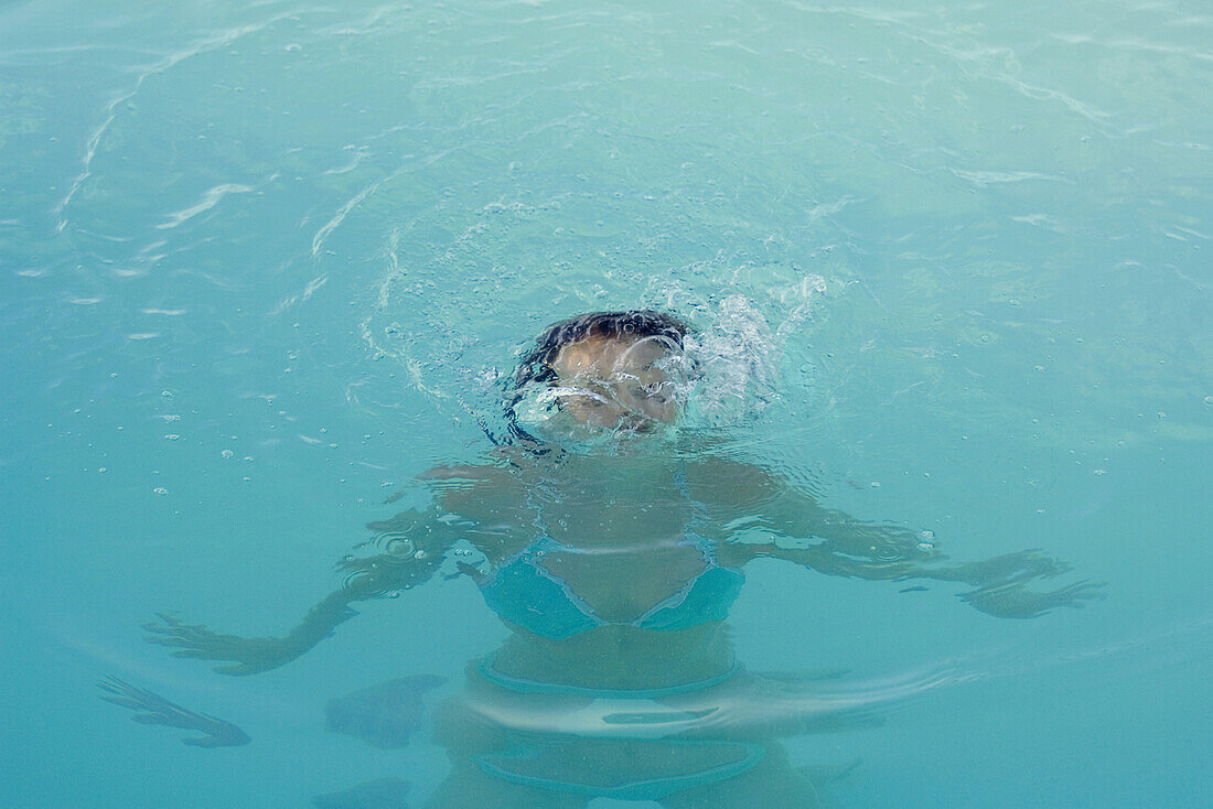 Woman emerging from water