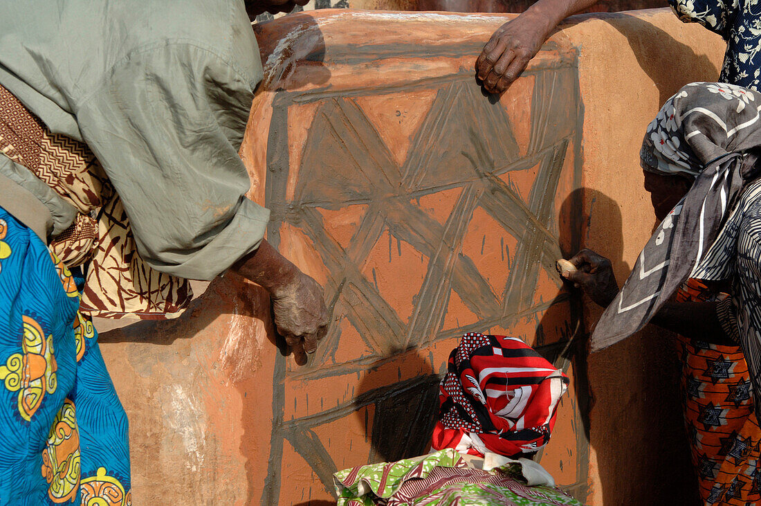 Burkina Faso, village of Tangasomogo, Cassena women create beautiful abstract frescoes that decorate the walls of their mud huts, situated in a round formation