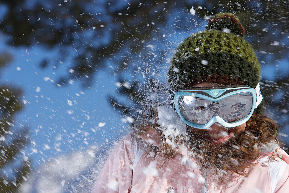 France, Alps, portrait of a teenage girl, snow ball in her face
