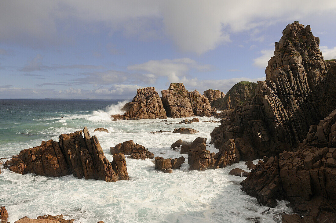 Strong waves at Cape Woolamai's Pinnacles, pink granite sculptured by rain and see, Phillip Island, Victoria, Australia