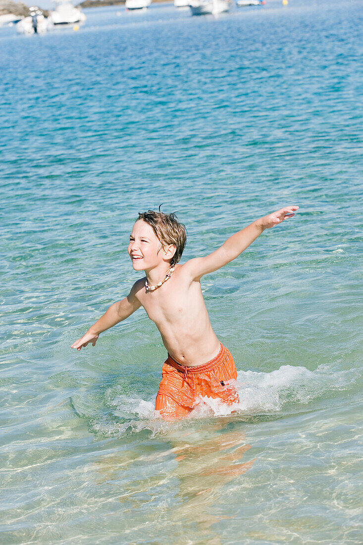 Boy running into sea