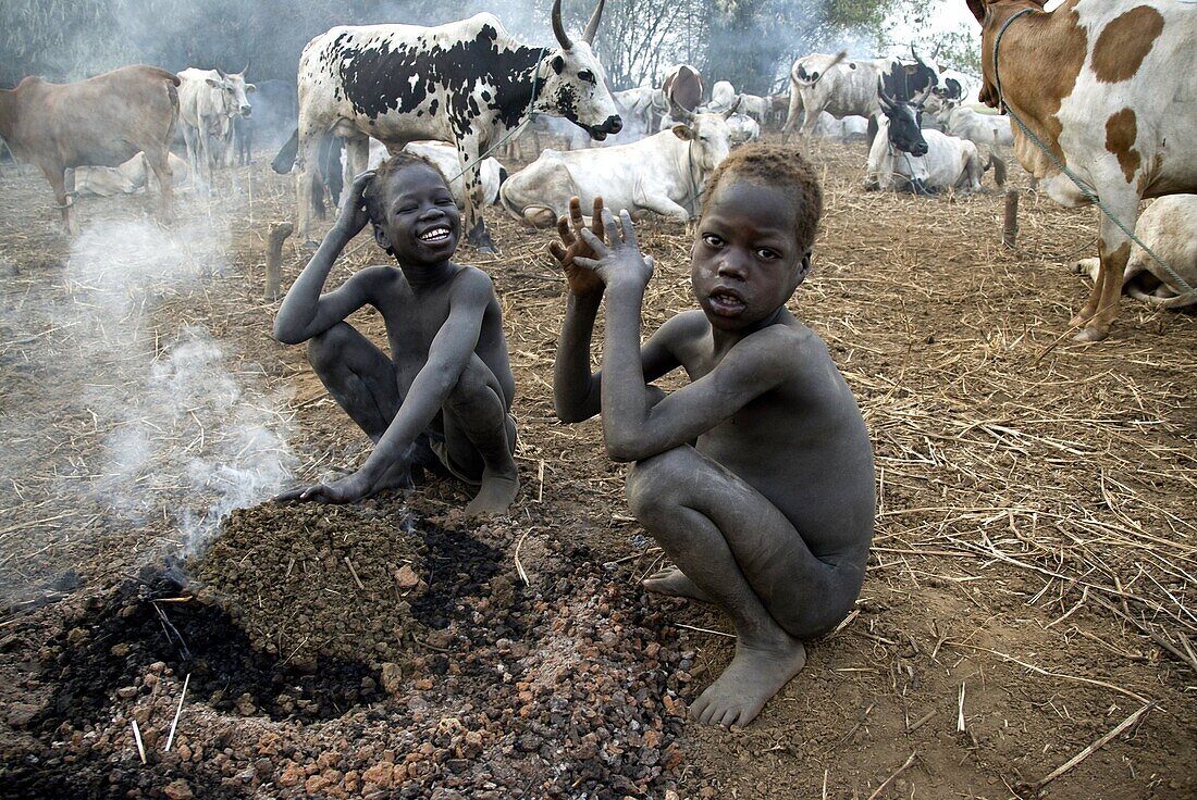 Ethiopie, Gambella, Anuak children warming up near a fire