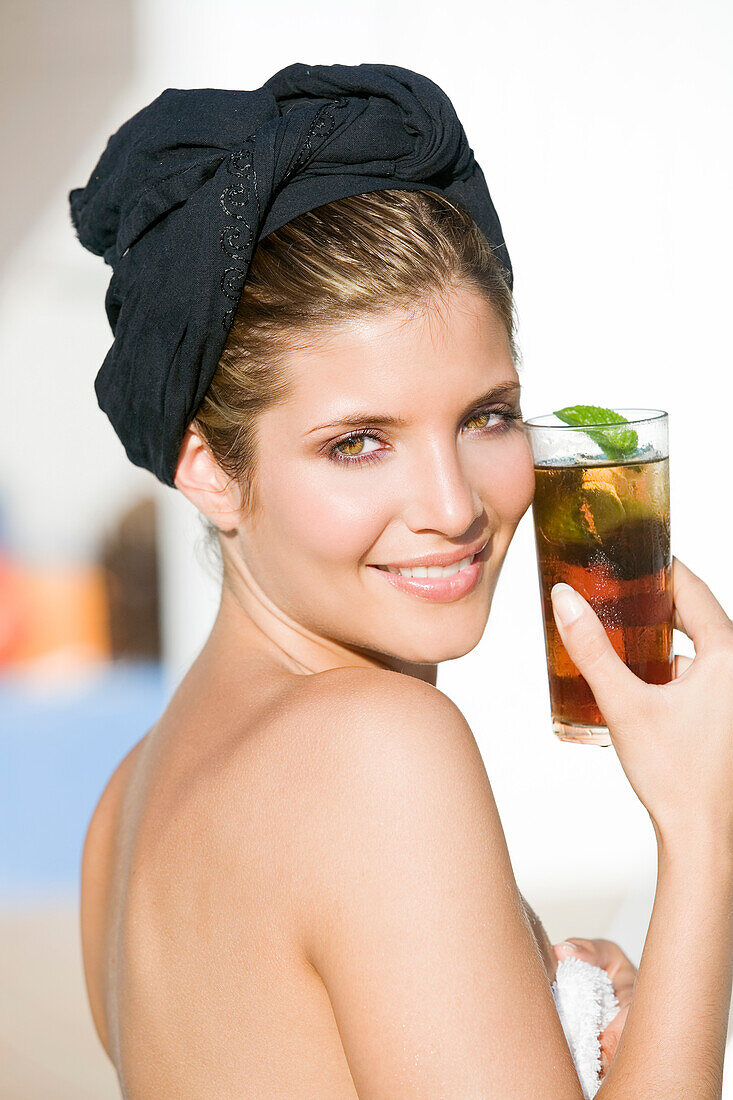 Young woman holding a glass of mint tea