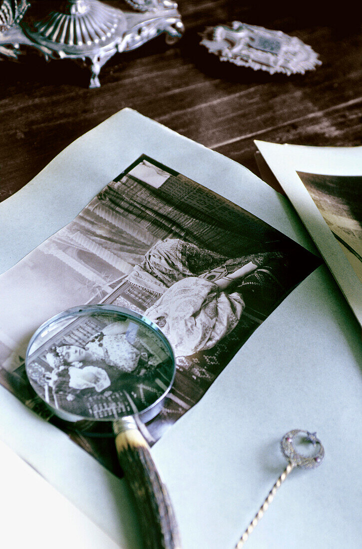 Magnifier and  ancient photograph on table, close-up