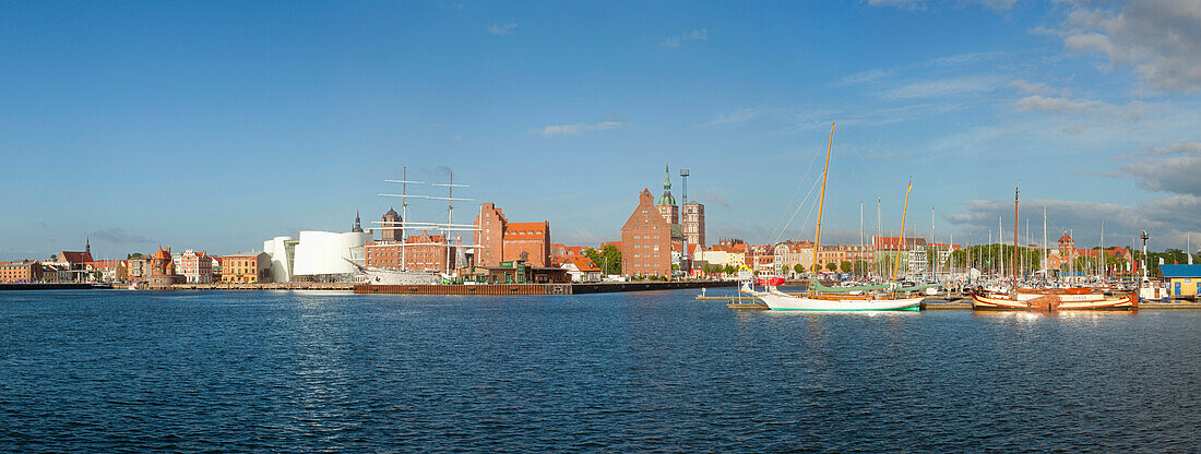 Panoramic view with Ozeaneum,  warehouses and sailing boats at harbour, St  Nicholas church in the background, Stralsund, Baltic Sea, Mecklenburg-West Pomerania, Germany, Europe