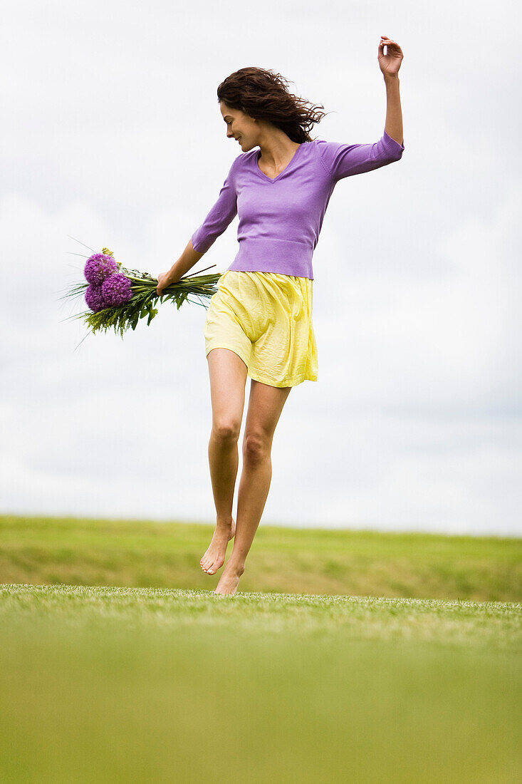 Young woman holding a bouquet of flowers