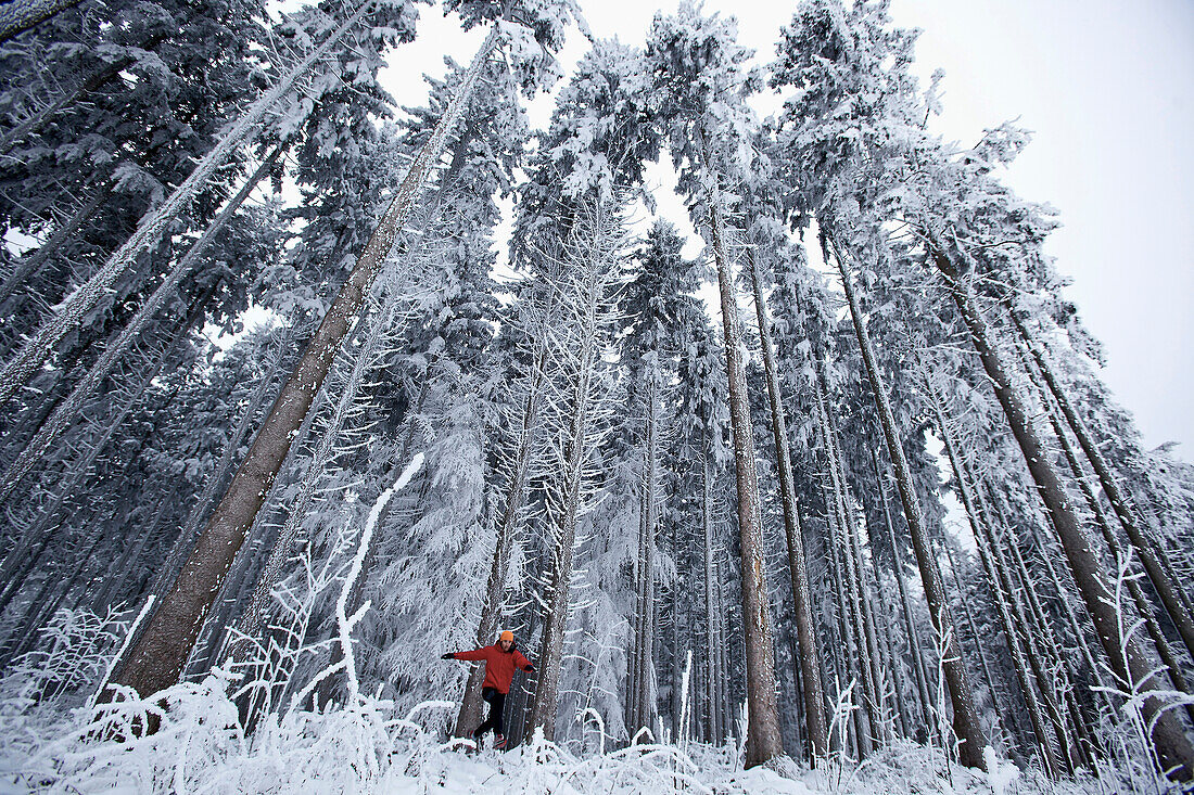 Man jogging through winter scenery, Irsee, Bavaria, Germany