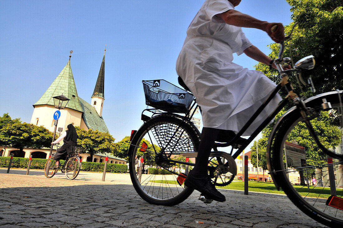 Cyclists at suqare Kapellplatz, Altötting, Bavaria, Germany, Europe