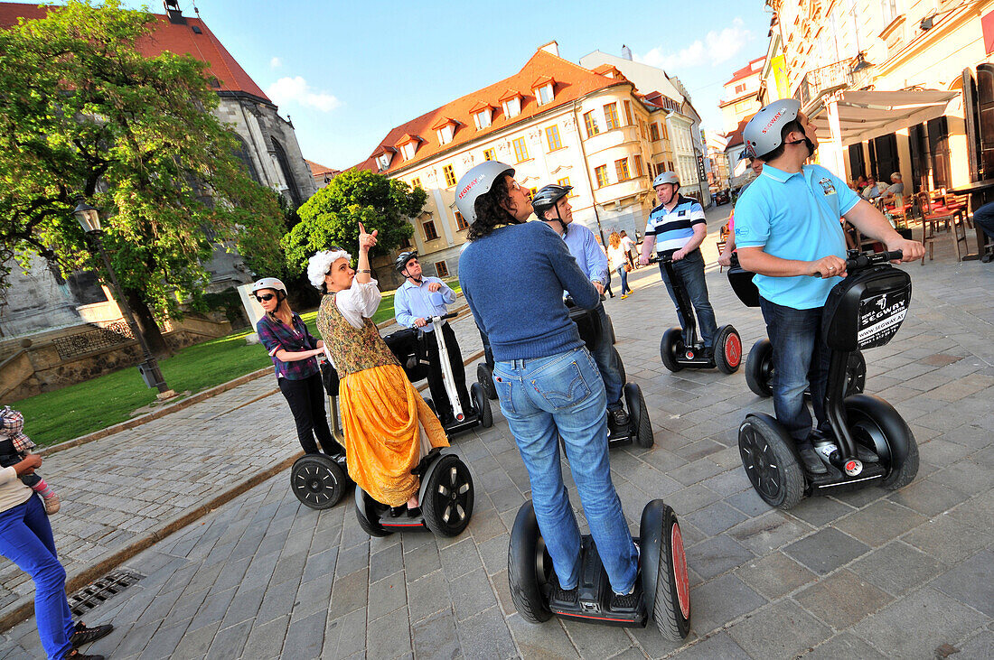 People on segways during a guided tour at the old town of Bratislava, Slovakia, Europe